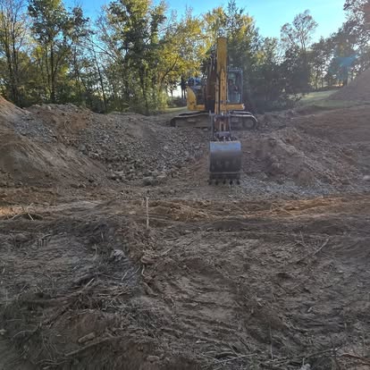 Excavator digging foundation area for construction