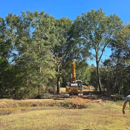Excavator clearing trees for residential land development