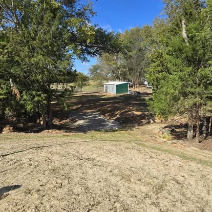 Graded property with cleared land and storage building